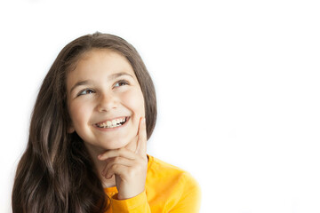 Happy positive smiling child girl with a long hair in yellow T-shirt isolated on white background