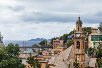 High angle view of the town of Zoagli, Italy on a cloudy day. In the background the promontory of Portofino