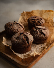 chocolate muffins on cutting board