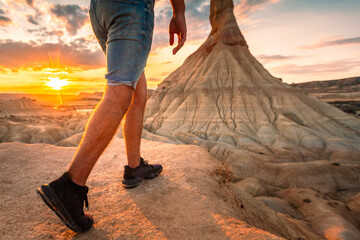 Young man legs walking into the desert of Bardenas Reales at Navarra, Basque Country.