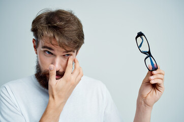 man vision problems in white t-shirt isolated background
