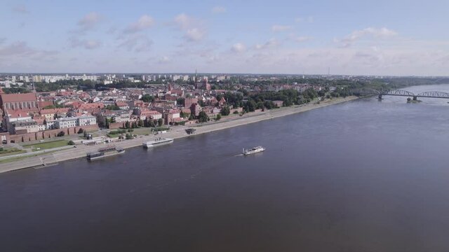 Torun, a Polish city during the day. A sunny and slightly cloudy day in Toruń on the Vistula River.