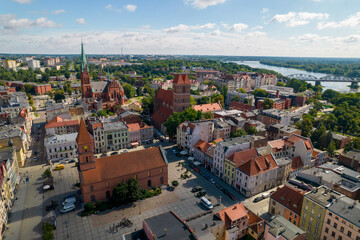 Fototapeta na wymiar Torun, a Polish city during the day. A sunny and slightly cloudy day in Toruń on the Vistula River.