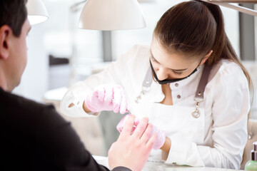 A Manicurist Cutting Off The Cuticle From The Person's Fingers