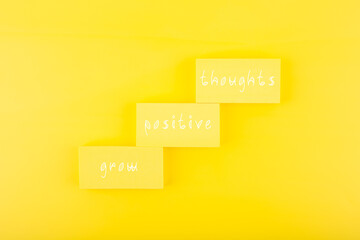 Positive affirmation or quote concept. Grow positive thoughts on yellow background with copy space