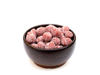 Tamarind candy in wooden bowl on white background