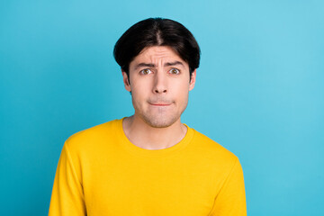 Photo of young man unhappy sad upset worried nervous problem trouble isolated over blue color background