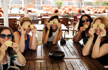 Women best friends sitting in summer cafe on the beach