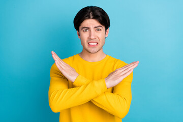 Photo of millennial brunet guy crossed arms wear yellow shirt isolated on blue color background