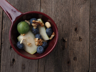 Organic food in a bowl on wood
