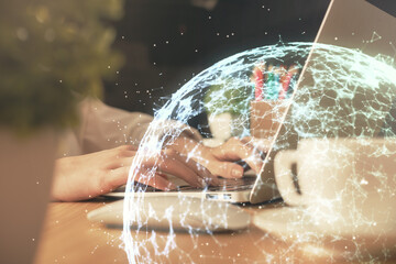 Double exposure of woman hands typing on computer and social network theme hologram drawing. People...
