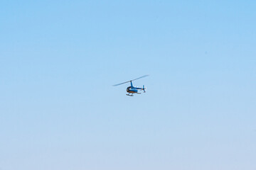 Helicopter flying in the sky during a sunny day