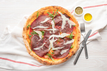 with bacon pizza on a beautiful aesthetic white tabl