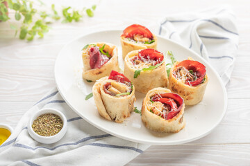 lavash rolled into a p with tomatoes and cheese