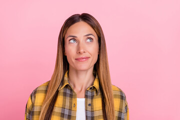 Portrait of gorgeous satisfied girl look interested empty space fantasize isolated on pink color...