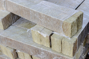 Rock mineral wool at a construction site. Close-up. Mineral wool folded on a pallet in cellophane packaging.