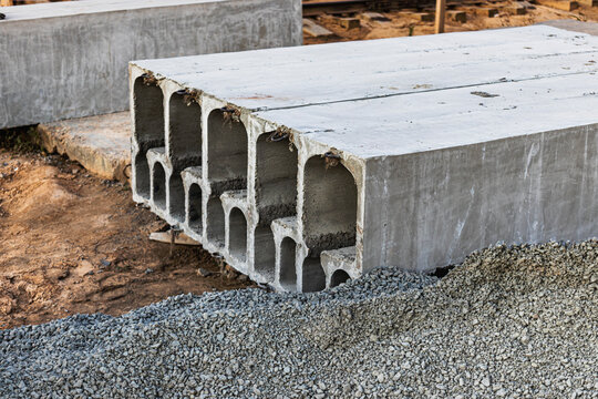 Many precast concrete wall panels are stocking in the storage area waiting for installation at construction site.