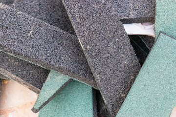 Remains of rubber floor covering for the playground. EPDM playground surface. Waste material after...