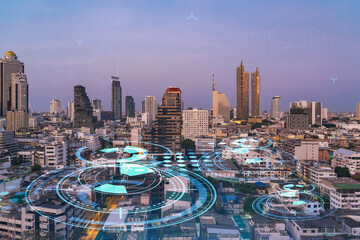 Glowing hologram of technological process, aerial panoramic cityscape of Bangkok at sunset. The...