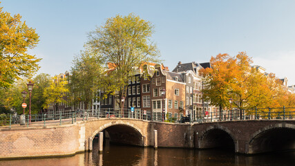 The Amsterdam canals, bridges and canal houses in the autumn season.