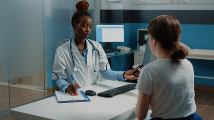 Medic giving bottle of pills to patient with sickness at checkup visit and medical appointment. Woman receiving prescription treatment and medicine in flask from doctor against disease.