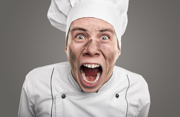 Mad chef with dirty face shouting at camera