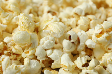 Tasty popcorn all over background, close up