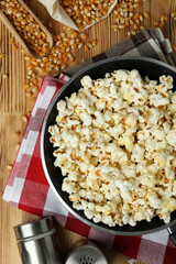 Concept of homemade popcorn on wooden background