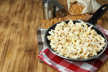 Concept of homemade popcorn on wooden background
