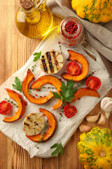 Concept of cooking with baked pumpkin on wooden background