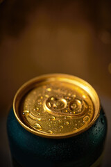 Close-up of golden beer can in a cozy bar light