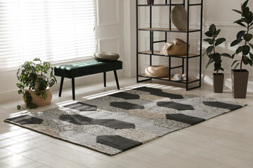 Stylish carpet with pattern on floor in room