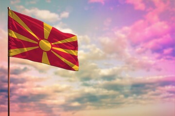 Fluttering Macedonia flag mockup with the space for your content on colorful cloudy sky background.