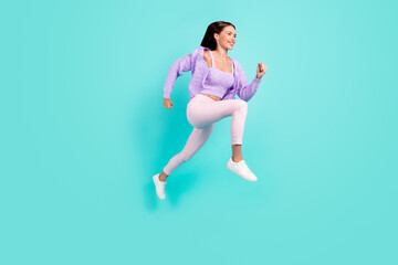 Profile photo of sportive active lady jump run empty space wear purple cardigan isolated teal color background
