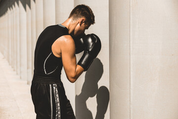 Man exercising and fighting in outside, boxer in gloves. male boxer portrait