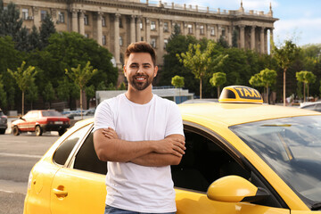 Handsome taxi driver near car on city street - obrazy, fototapety, plakaty