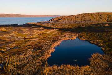 Aerial view of lake in tundra on the coastline of Barents sea, north of russia in autumn