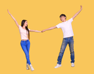 Fototapeta premium young couple being happy and dancing