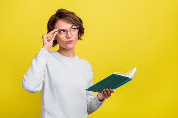 Photo of geek nerd student lady read book look empty space wear eyewear blue pullover isolated...
