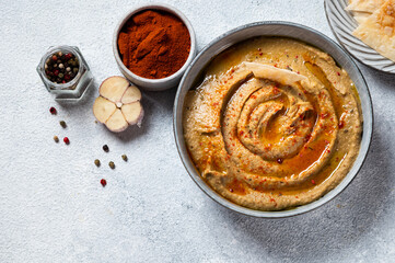 Traditional arabian eggplant dip baba ganoush with herbs and smoked paprika on light background. Eggplant hummus. Babaganush or eggplant caviar. Baked eggplant. Turkish eggplant dip