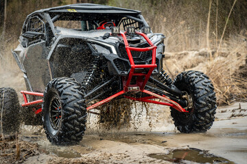 ATV/UTV/4x4 off-road vehicle in muddy water