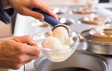 ice cream razor with ice cream ball in background of refrigerated display case