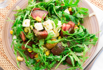 mixed salad of arugula and fresh vegetables with sauce