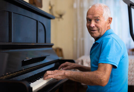 Senior Man Learning To Play Piano