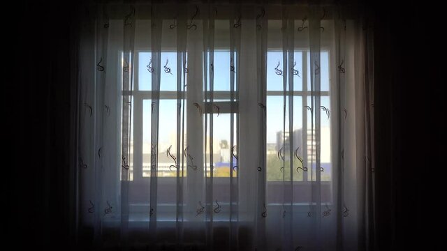 4K frames of a window with curtains from the side of the room