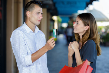 rich man is giving debit card to his girlfriend