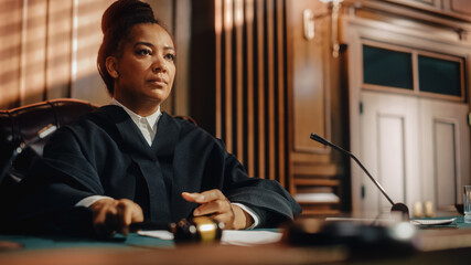 Court of Law Trial in Session: Portrait of Honorable Female Judge Reading Decision. Presiding Justice Pronouncing Sentence. Not Guilty Verdict Judgment. © Gorodenkoff