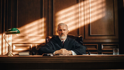 Cinematic Court of Law and Justice Trial: Portrait of Impartial Male Judge Listening To the Pleaded Case. Unbiased Decision after Hearing Arguments. Deliberation on Guilty, Not Guilty Verdict. - obrazy, fototapety, plakaty