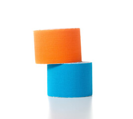 Blue and orange medical kinesiology tape on a white background. Isolate, teping, close-up