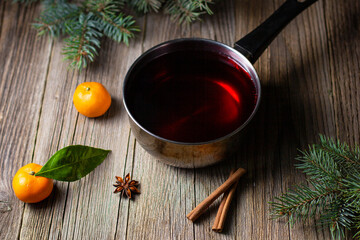 tasty mulled wine hot drink with mandarin orange apple spices and christmas tree in pot